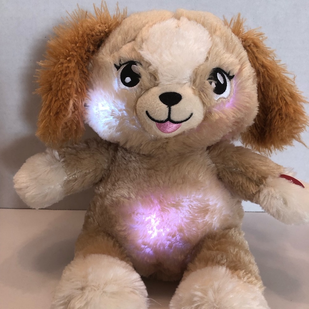 Lullabrites puppy plush plays 3 songs for bedtime. Changes to different lights.